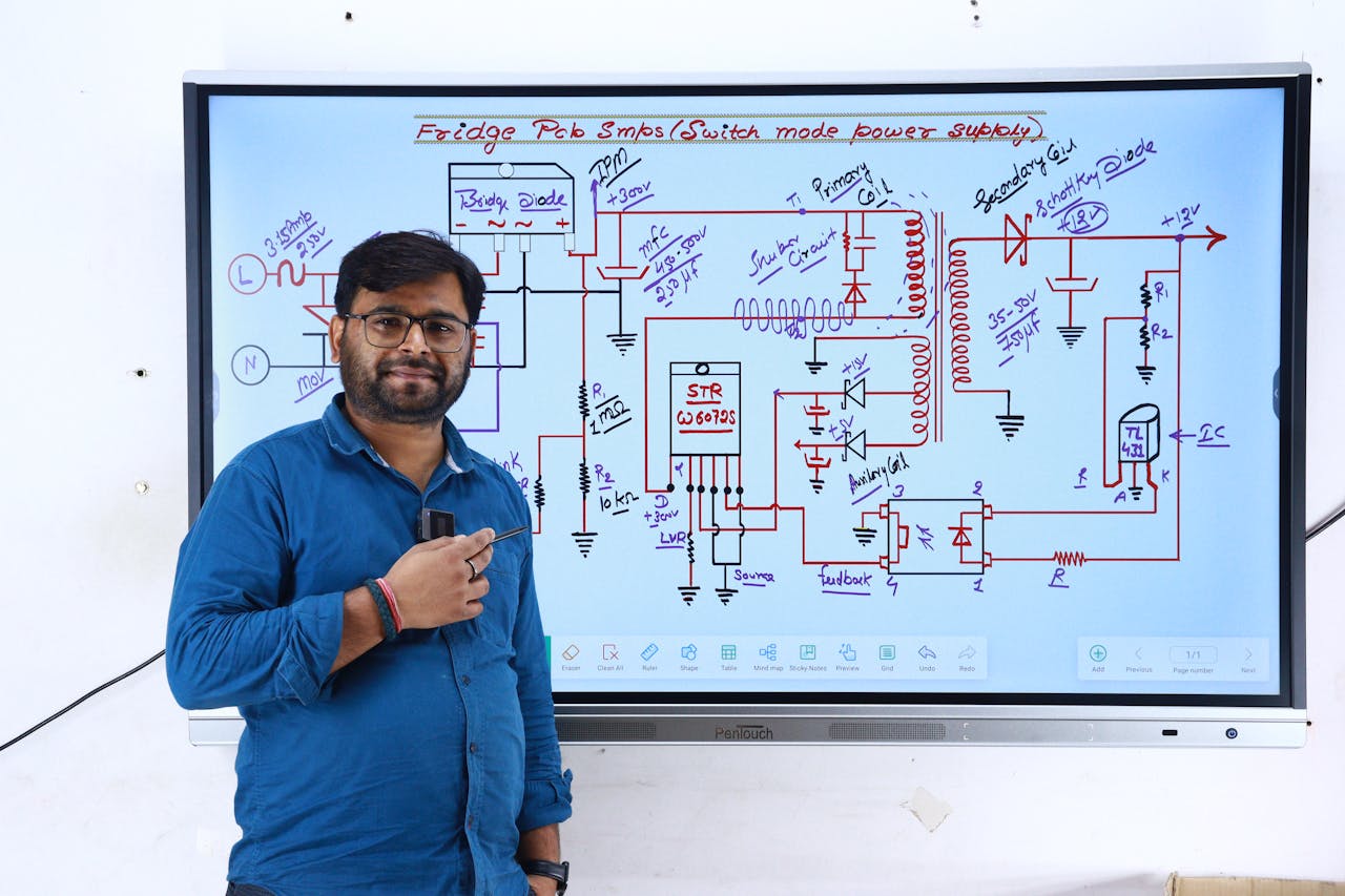The Art of Drawing Readers In: Your attractive post title goes here Instructor in New Delhi teaching electronics with a circuit diagram on screen.