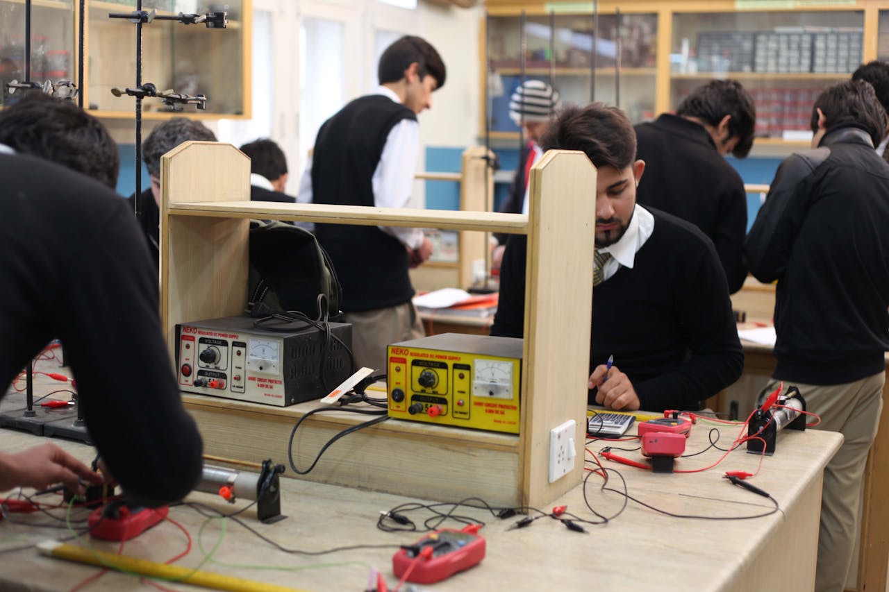 Students working on electronics projects in a lab, focusing on practical learning.
